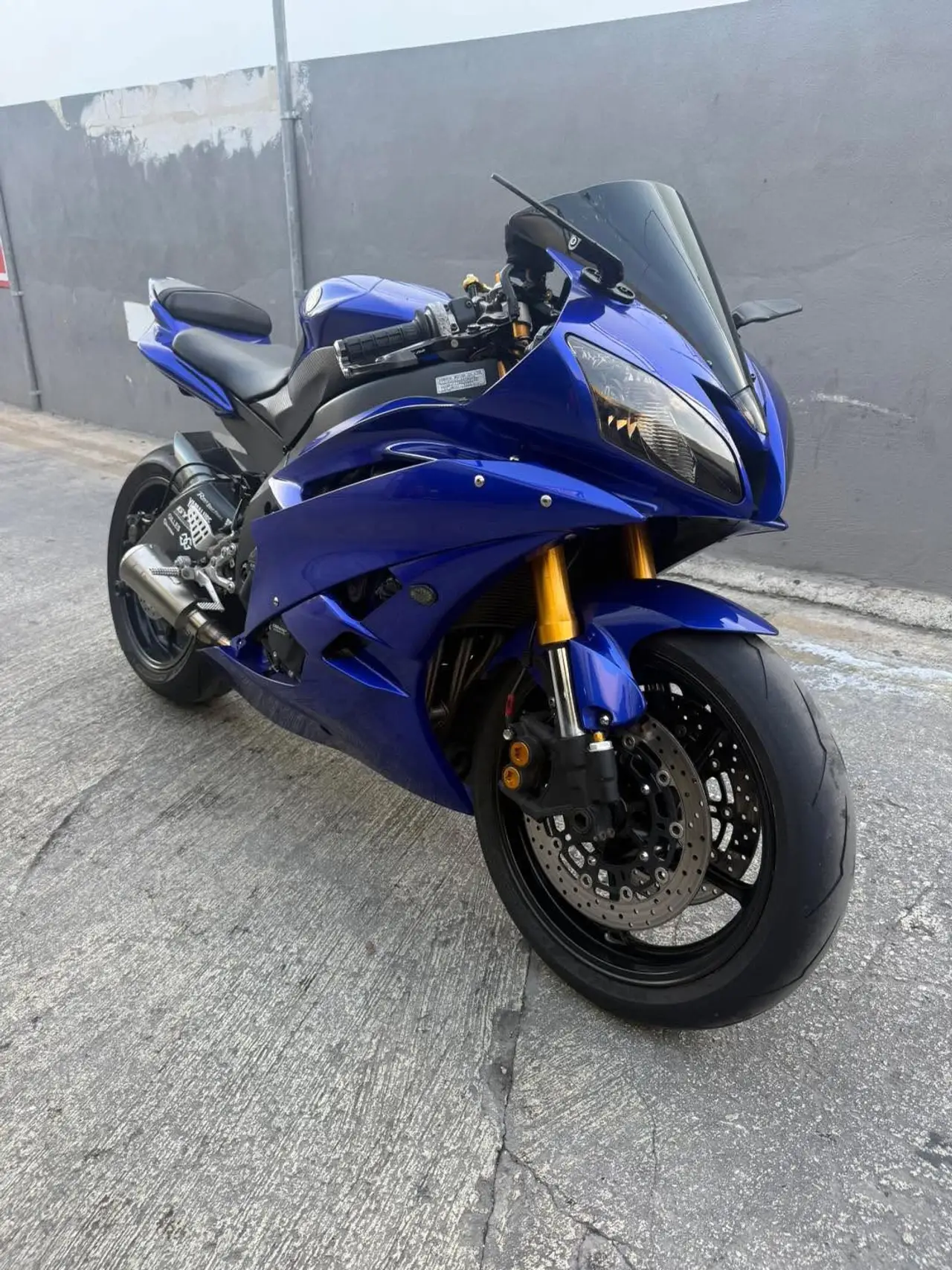 Blue sport motorcycle with gold front forks