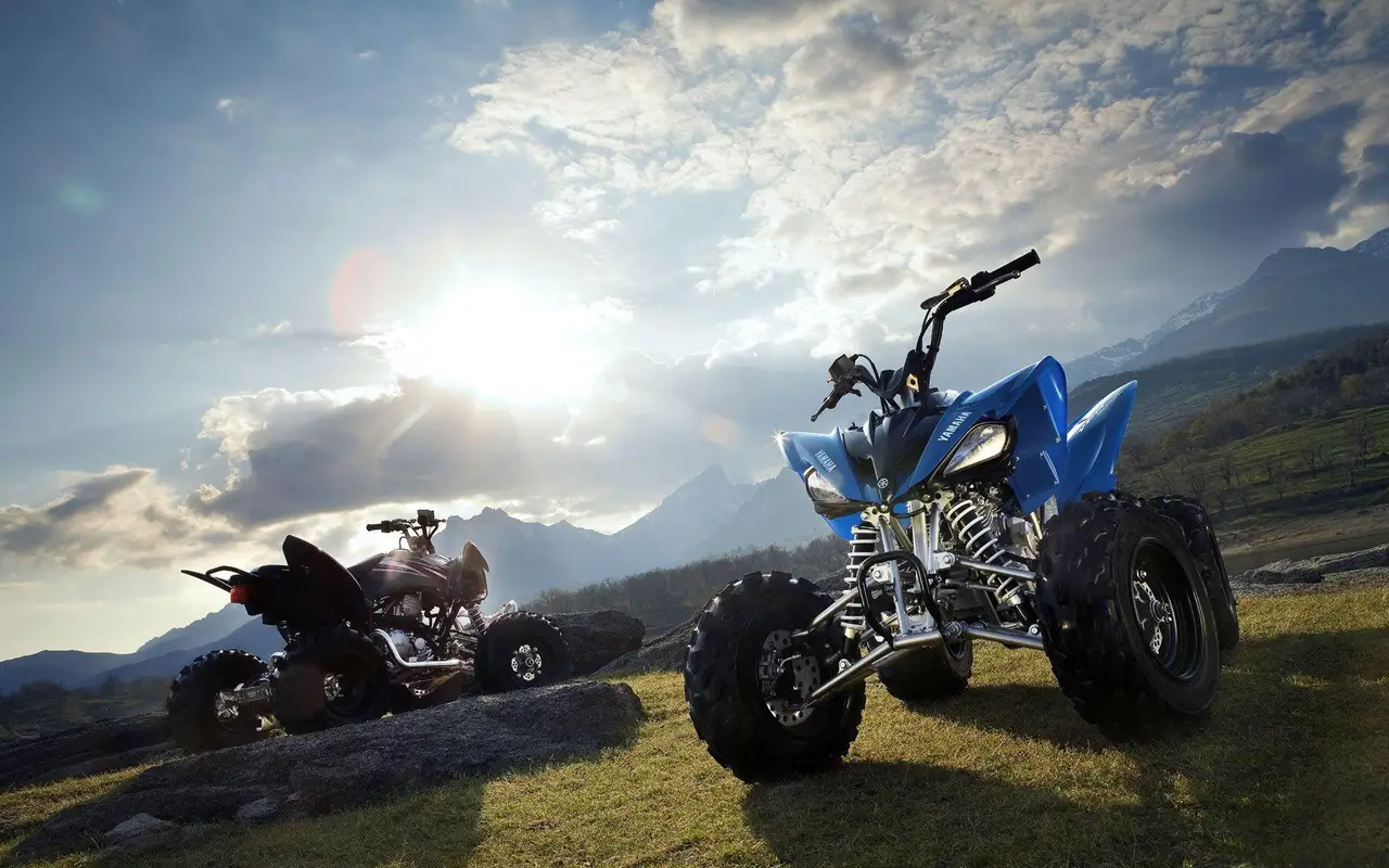 Two sport quads in dramatic mountain terrain